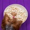 Head of a Yorkshire terrier next to a bowl of popcorn