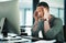 This headache couldnt have come at a worse time. a young businessman struggling with a headache while using a computer