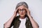 headache. mature grey haired woman experiencing migraine. Upset, frustrated senior woman touching her head suffering