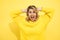 Headache, migraine, young beautiful woman, blonde, screaming, clutching head with hands, Studio shot on yellow background