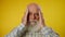 Headache. Portrait of an elderly gray-haired bearded man in a shirt who has a headache and rubs his temples with his