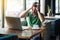 Headache, problem or confusion! Young businessman in green t-shirt sitting and holding his painful head. business and freelancing