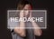 Headache word with woman holding temples and suffering from real head ache