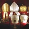 Headdresses of priests on a red background