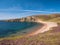 With the headland of Burki Taing in the distance, the sandy beach at Muckle Ayre on the south coast of Muckle Roe, Shetland