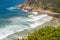 Headland jutting into the sea with railway tunnel and tracks next to bay