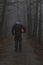 Headless man with Halloween pumpkin in foggy forest