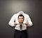 Headless man holding crying head on white plate