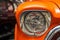 Headlight lamp vintage car. Classic car headlight. Close-up of headlights of orange vintage car. Exhibition