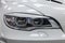 Headlight with lining view of luxury very expensive new white BMW X6 M Lumma CLR tuning car stands in the washing box waiting for