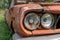 Headlight of an old rusty abandoned car, utilisation and scrap concept