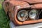 Headlight of an old rusty abandoned car, utilisation and scrap concept