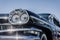 Headlight of a oldtimer in front of blue sky