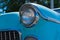 Headlight of a oldtimer in front of blue sky