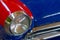 The headlight of a red antique, rarity, vintage car