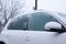 Headlights with icicles and snow in winter season scraping ice from a windshield . Windshield Frozen car winter