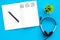 Headphone with paper note in music studio for dj or musician work blue background top view space for text