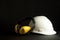 Headphone Safety with white hardhat on black background