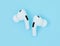 Headphones Apple Air Pods Pro 2 on blue background, top view. AirPods are wireless Bluetooth earbuds designed by Apple Inc