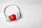 Headphones, heart and space for text on white background, top view