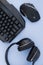 Headphones, mouse, keyboard on the blue background, top view. Gamer background