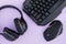 Headphones, mouse, keyboard on the pink background, top view. Gamer background. Computer devices