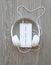 Headphones and smartphone with word `Your text here` on white screen against wooden background