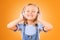 Headphones, smile or child streaming music to relax with freedom in studio on orange background. Face, singing or happy