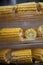 Heads of corn laid out for cooking in a double boiler. Corn broken into pieces in a steamer.