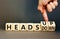 Heads up or down symbol. Concept words Heads up Heads down wooden cubes. Businessman hand. Beautiful grey table grey background.