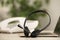 Headset, desktop telephone and laptop on table indoors, closeup. Hotline concept