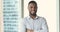 Headshot ambitious African businessman posing in office with arms crossed