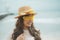 Headshot of beautiful asian woman wearing yellow eye glasses standing at sea beach