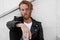 Headshot of brutal man with ginger beard, looks thoughtfully straight, posing over black background with free space.