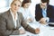 Headshot of business woman at negotiation. Group of business people discussing questions at meeting in modern office