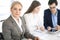 Headshot of business woman at negotiation. Group of business people discussing questions at meeting in modern office