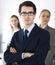Headshot of businessman standing straight with colleagues at background in office. Group of business people discussing