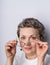 Headshot of a candid looking gray haired woman 40-50 with glasses