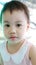 Headshot of charming 3 years old cute baby Asian girl, little toddler child with adorable brown less hair
