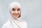 Headshot of cheerful cute millennial middle eastern woman in hijab looks at camera