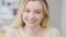 Headshot of cheerful happy beautiful young woman laughing looking at camera. Close-up portrait of joyful positive