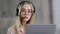 Headshot close up caucasian young girl woman helpline agent manager wearing headset with microphone looking at web