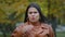 Headshot close-up young attractive worried sad hispanic woman standing outdoors shocked by negative news upset feeling