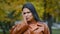 Headshot close-up young attractive worried sad hispanic woman standing outdoors shocked by negative news upset feeling