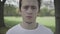 Headshot of furious young Caucasian man yelling at camera. Close-up portrait of angry brunette guy shouting out loud