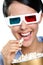 Headshot of the girl in 3D glasses eating popcorn