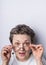 Headshot of a gray haired woman 40-50 with glasses having playful expression on her face