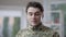 Headshot of handsome young military man adjusting hair and winking looking at camera smiling. Close-up portrait of