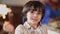 Headshot happy Middle Eastern boy with Christmas sparkler looking at camera smiling. Close-up portrait relaxed child