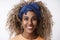 Headshot lively and enthusiastic, carefree stylish african-american curly-haired blond female in blue hipster headband